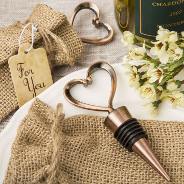 Heart shaped metal bottle stopper in a Copper plated finish  in a burlap bag