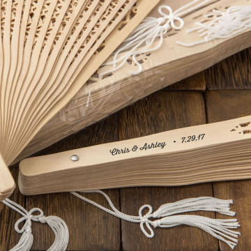 Intricately carved personalized Sandalwood fan favors